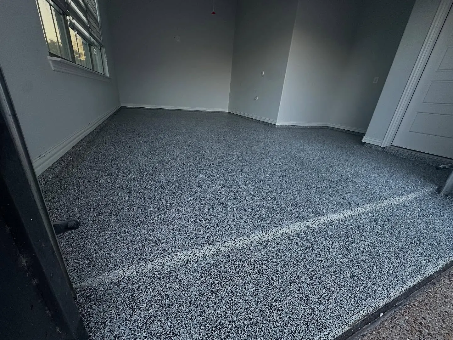 Finished black and gray flake polyaspartic garage floor in Fort Worth, TX